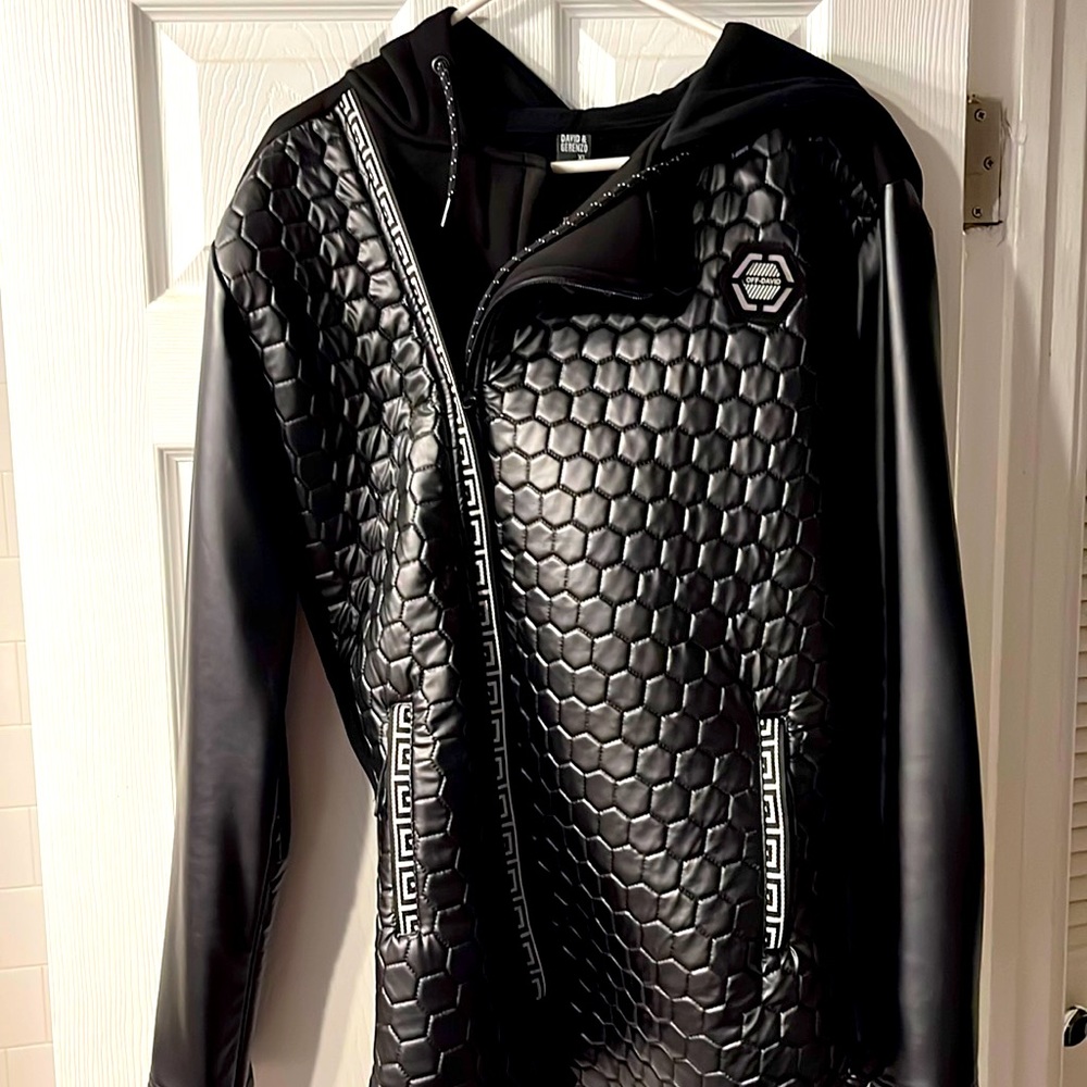 Stylist black jacket and hoodie with leather sleeves and a hive print front
